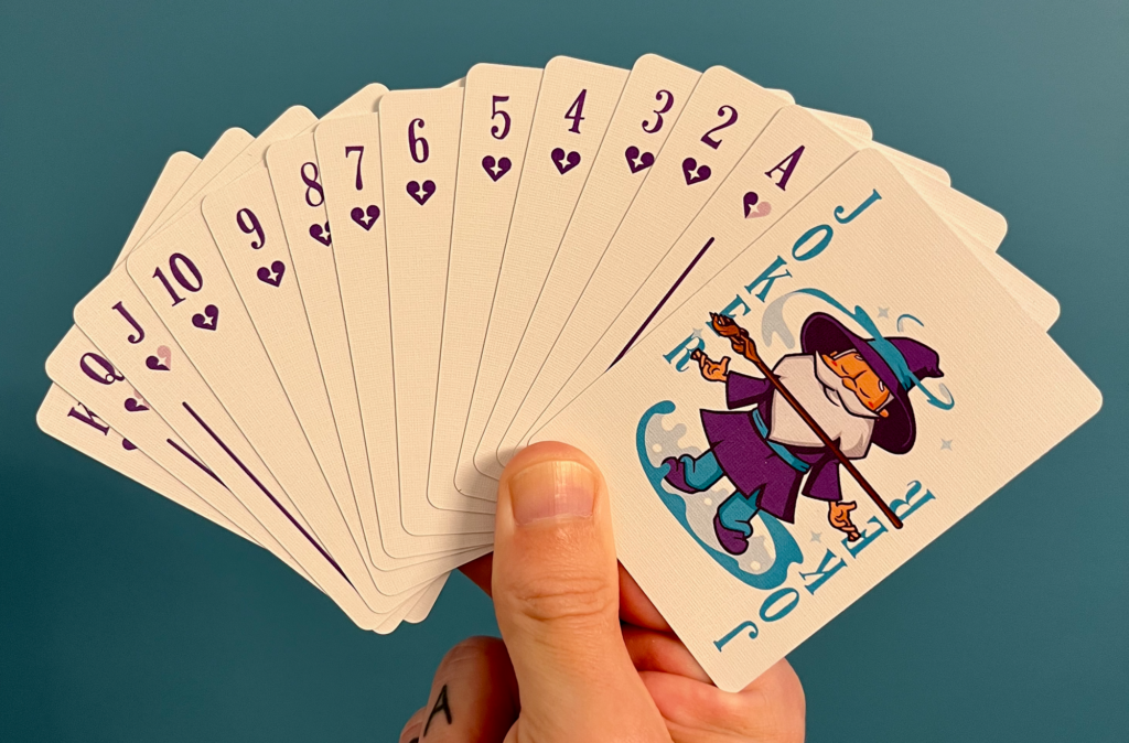 Scott holding a spread of Gravity Perks playing cards.